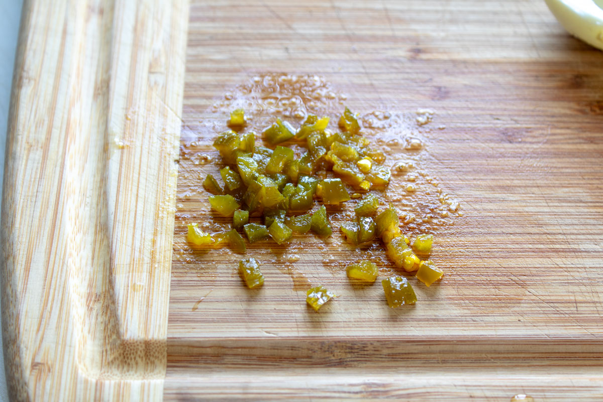 Diced jalapeños on a cutting board.