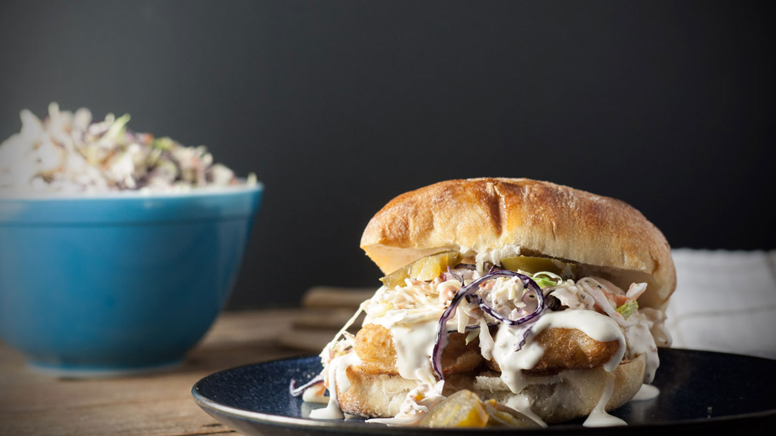 Spicy fish sandwich with coleslaw on a plate