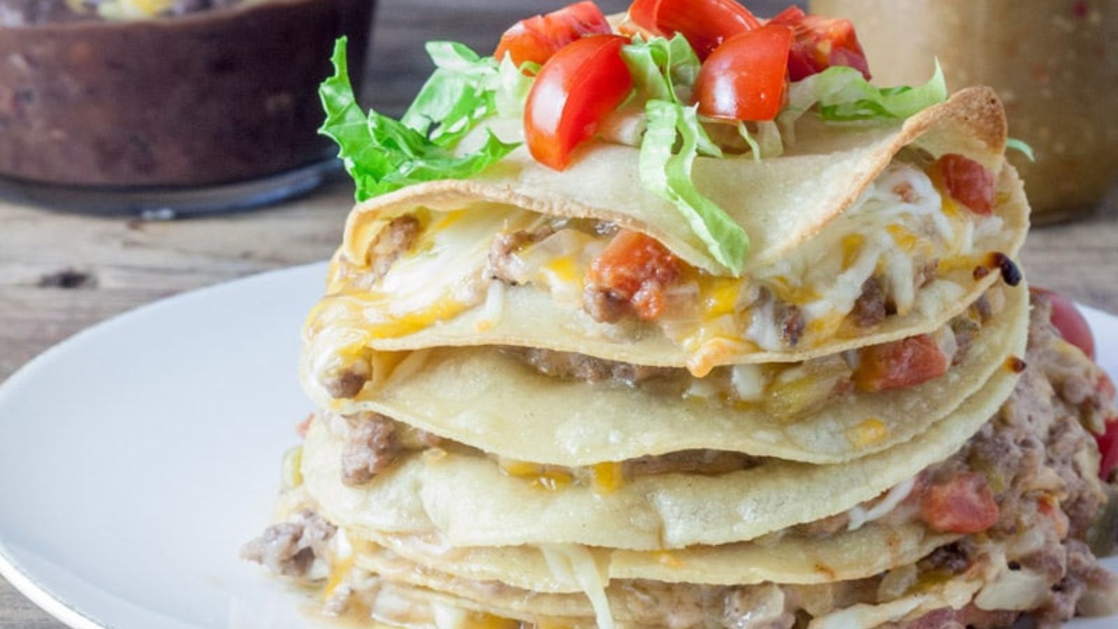 Stacked, fried tortillas with meat filling and cheese between the layers.