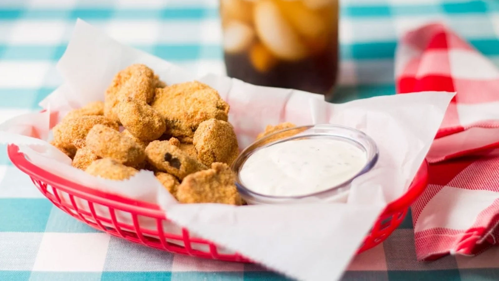 Fried pickles in a red tray.