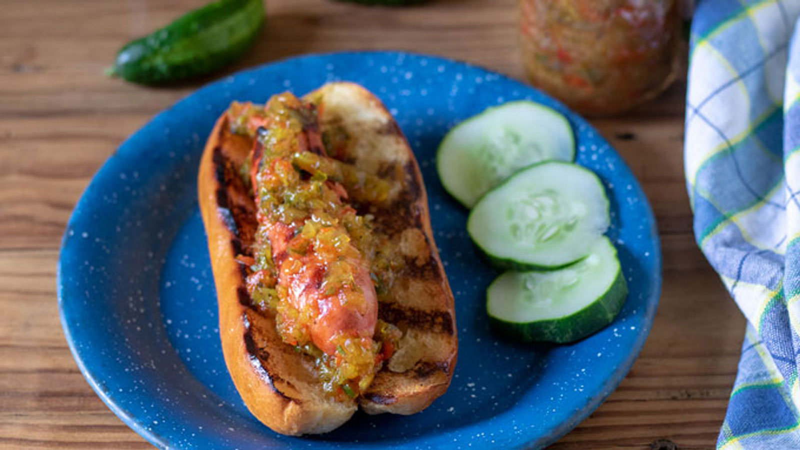 Sweet relish on a hot dog in a bun.
