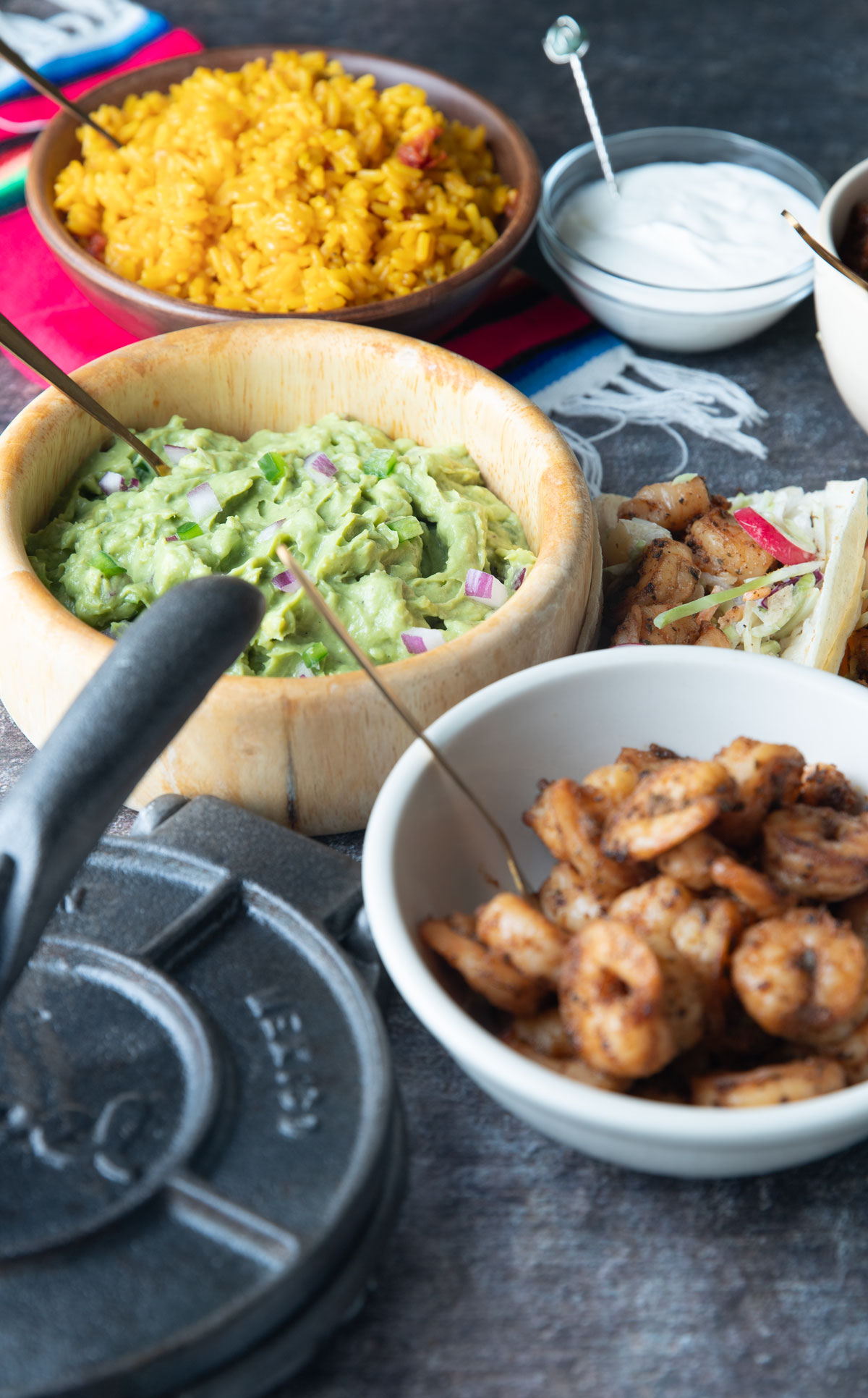 Shrimp taco filling, guacamole and Mexican rice in bowls.