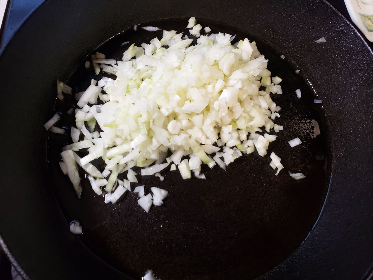 Onions sautéing in a skillet.