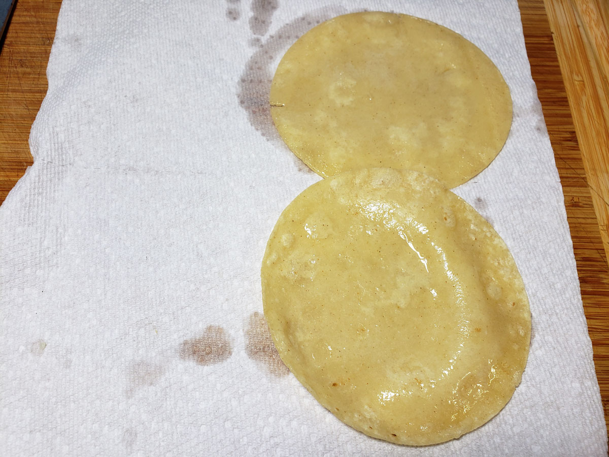Draining the tortillas on paper towels.