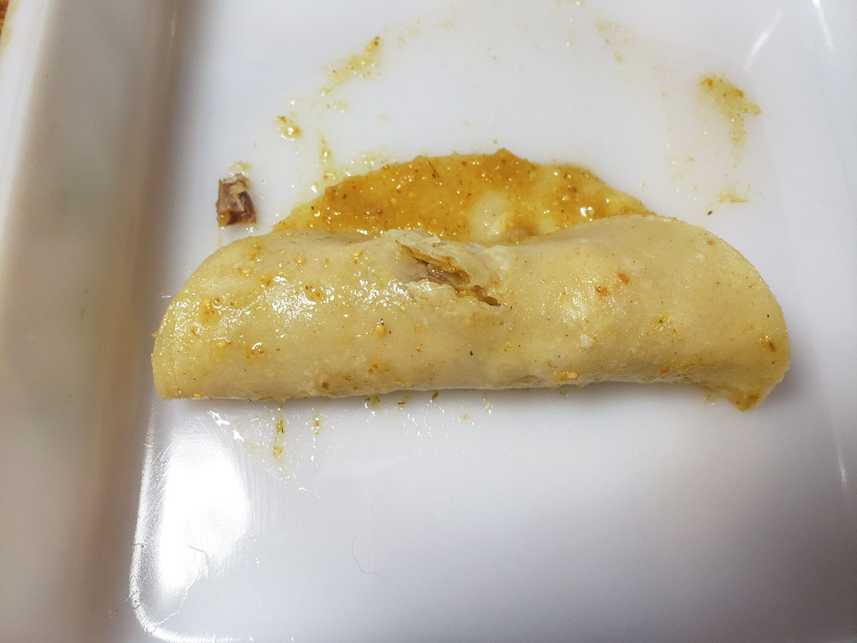 Rolling the tortilla up.