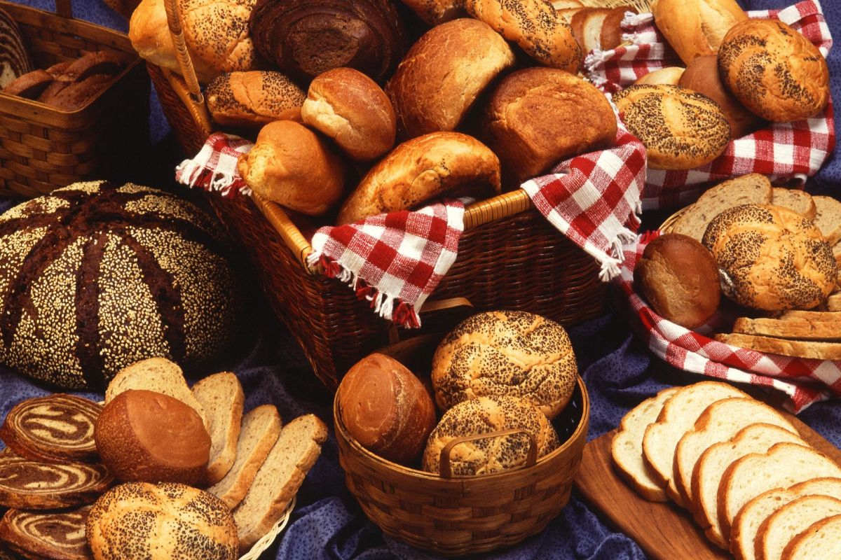 Multiple types of bread on a black board.