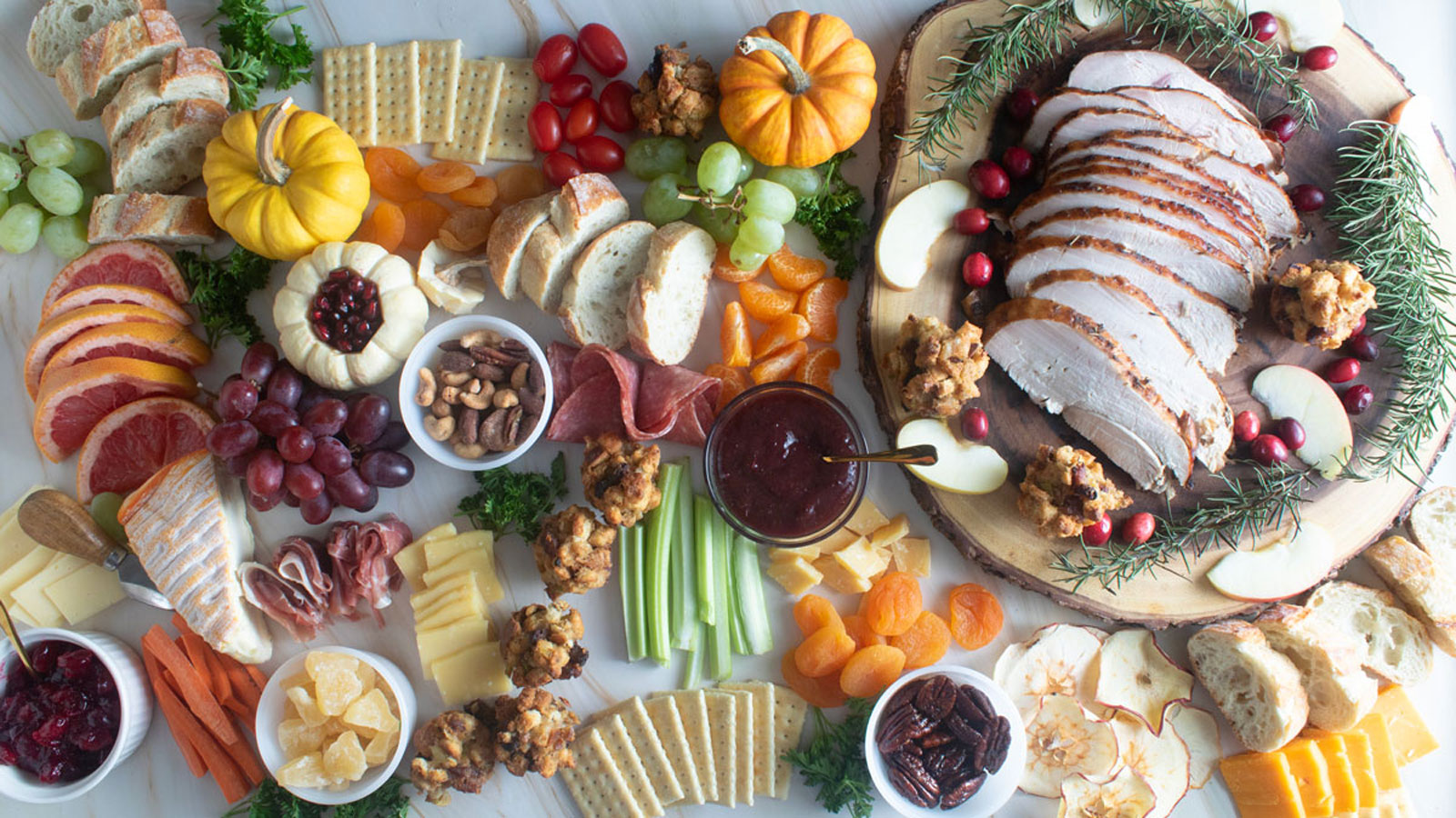 Fall themed charcuterie with sliced turkey, stuffing, nuts, dried apples and more.
