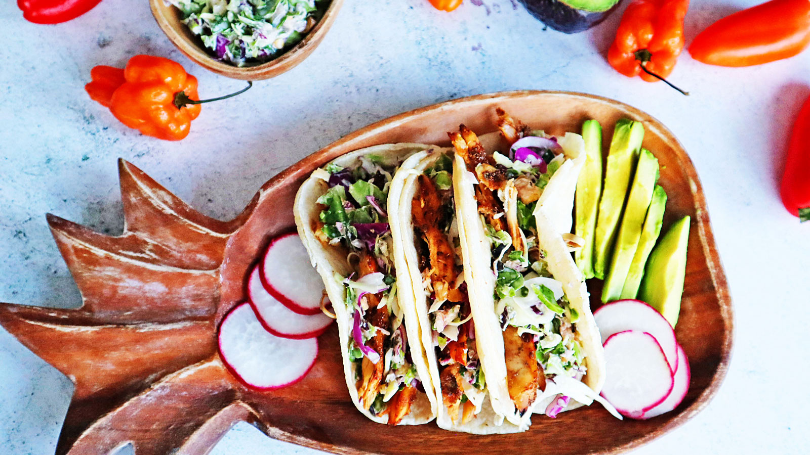Jerk chicken tacos on a pineapple-shaped  platter.