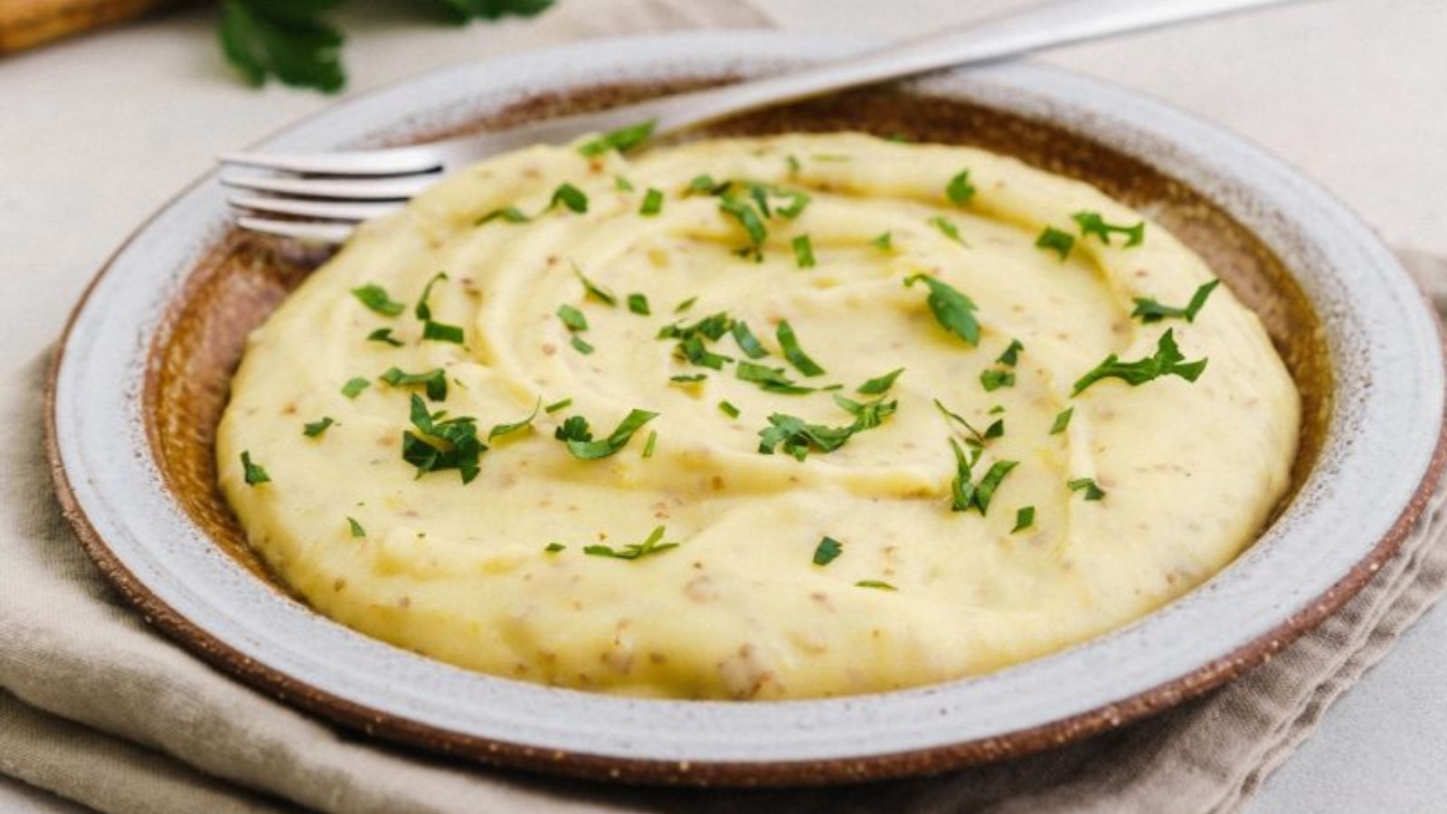 Mashed potato with garnish of parsley on top.