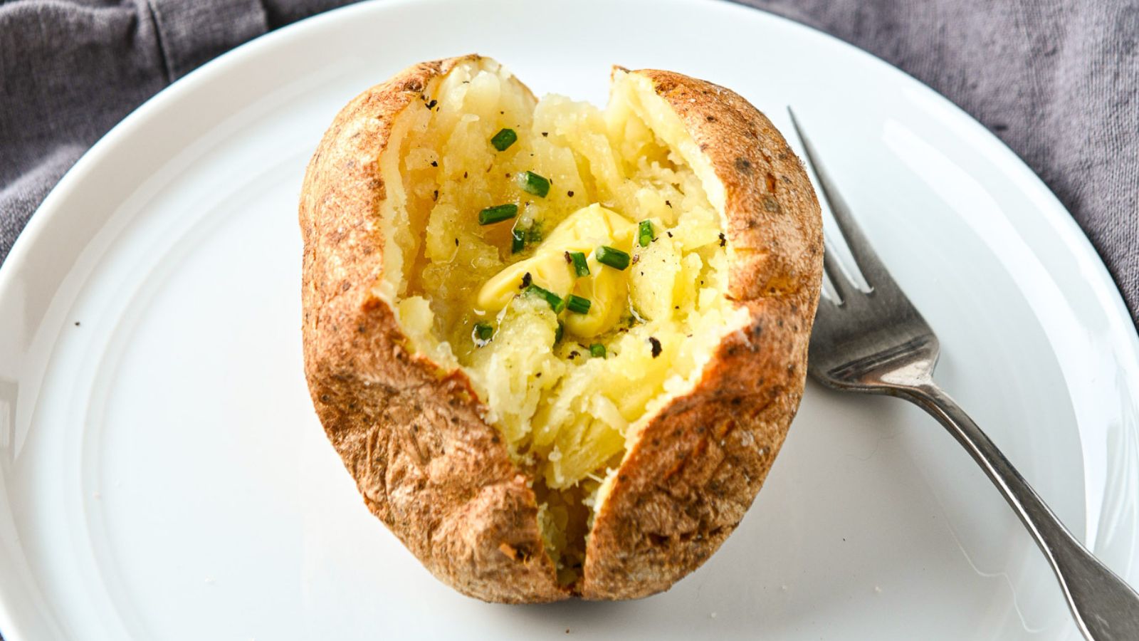 Baked potato with garnishes in the middle.
