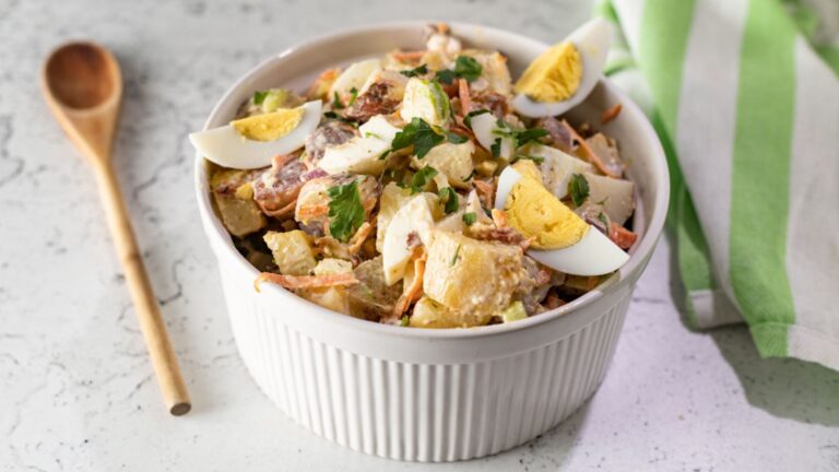 Bacon, potato and egg salad in a bowl.