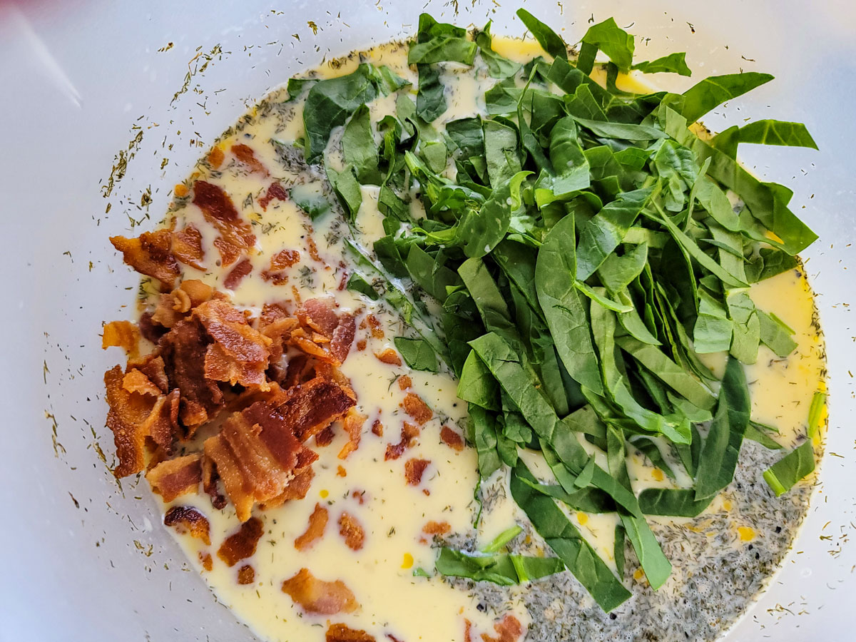Bacon and spinach added to the egg mixture.
