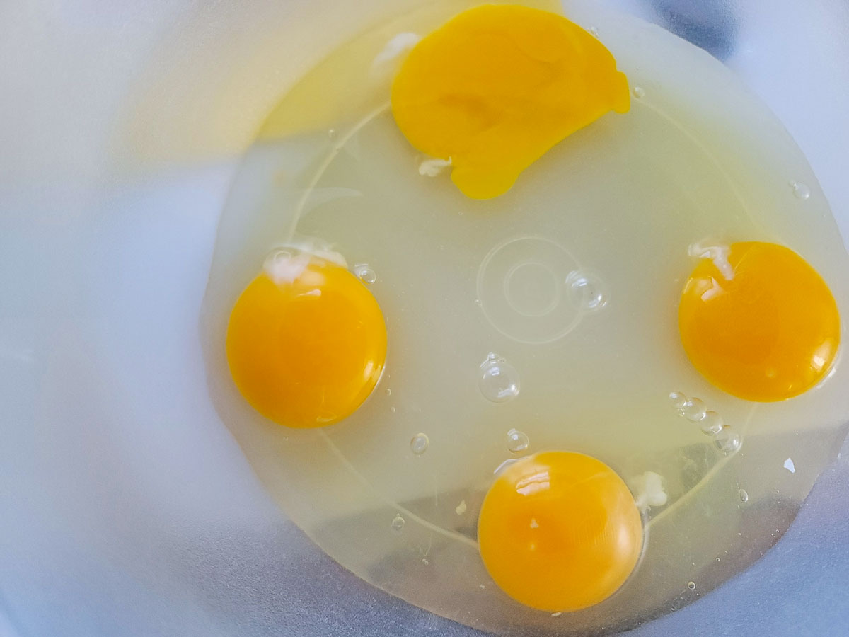 Eggs cracked into bowl.
