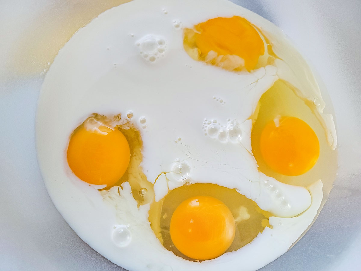 Milk added to the cracked eggs.