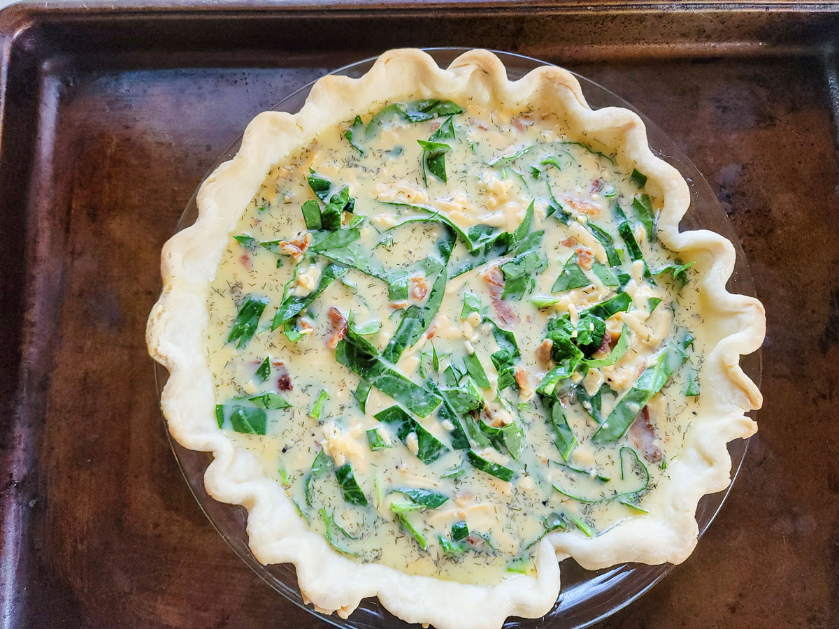 Pie plate placed on a rimmed baking sheet to catch drips.