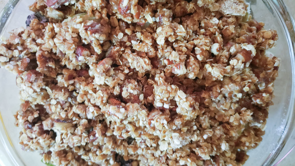Topping spread on top of the fruit in a casserole dish.
