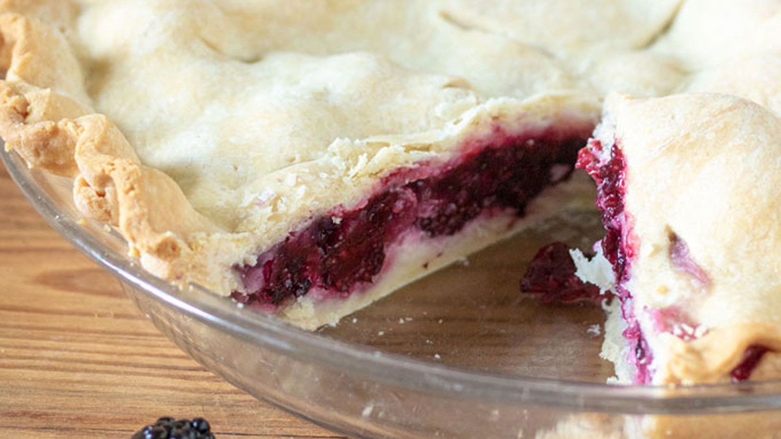 Blackberry pie with slice.