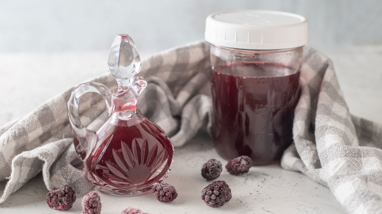 Blackberry vinegar in a jar and a cruet.