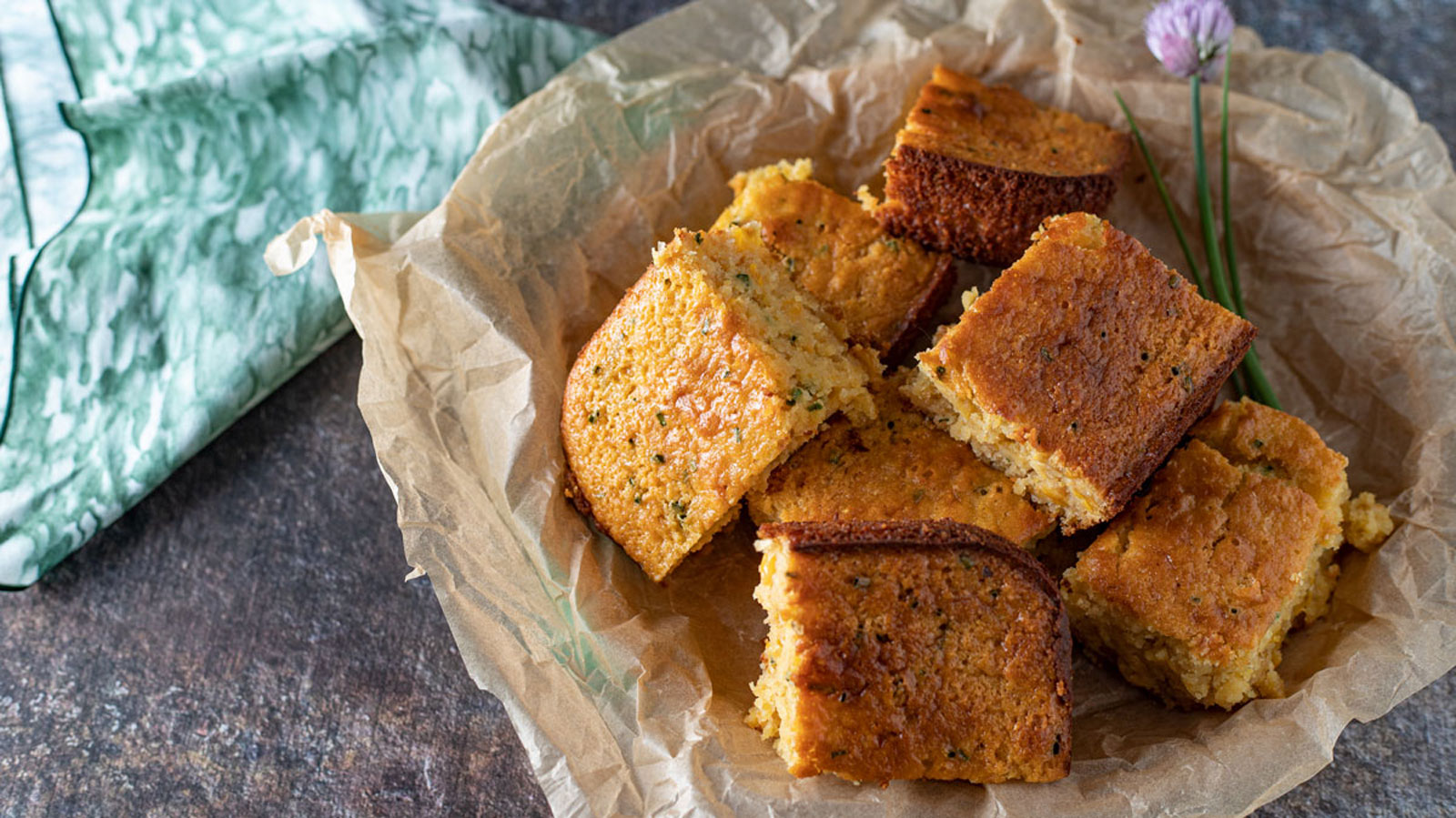 Squares of cornbread in a wicker basket.