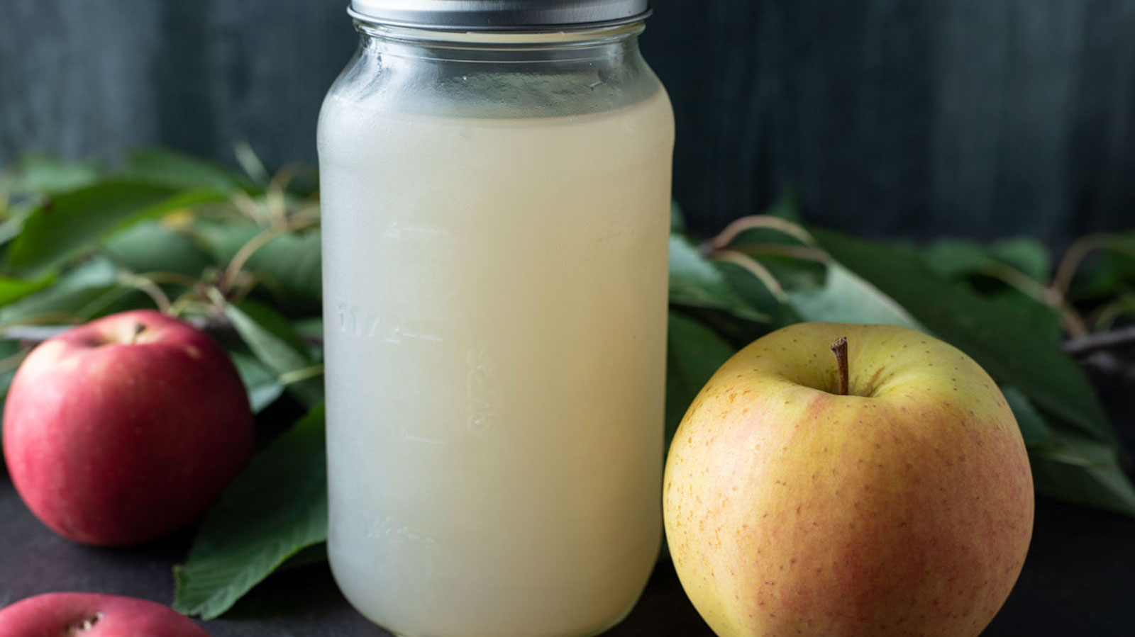 Canned apple juice in quart jar.