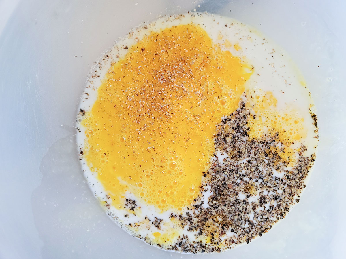 Milk and spices added to eggs.