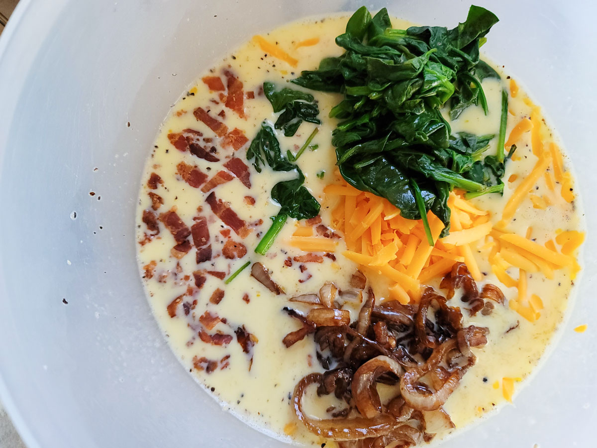 cheese, onions and spinach added to the egg mixture.