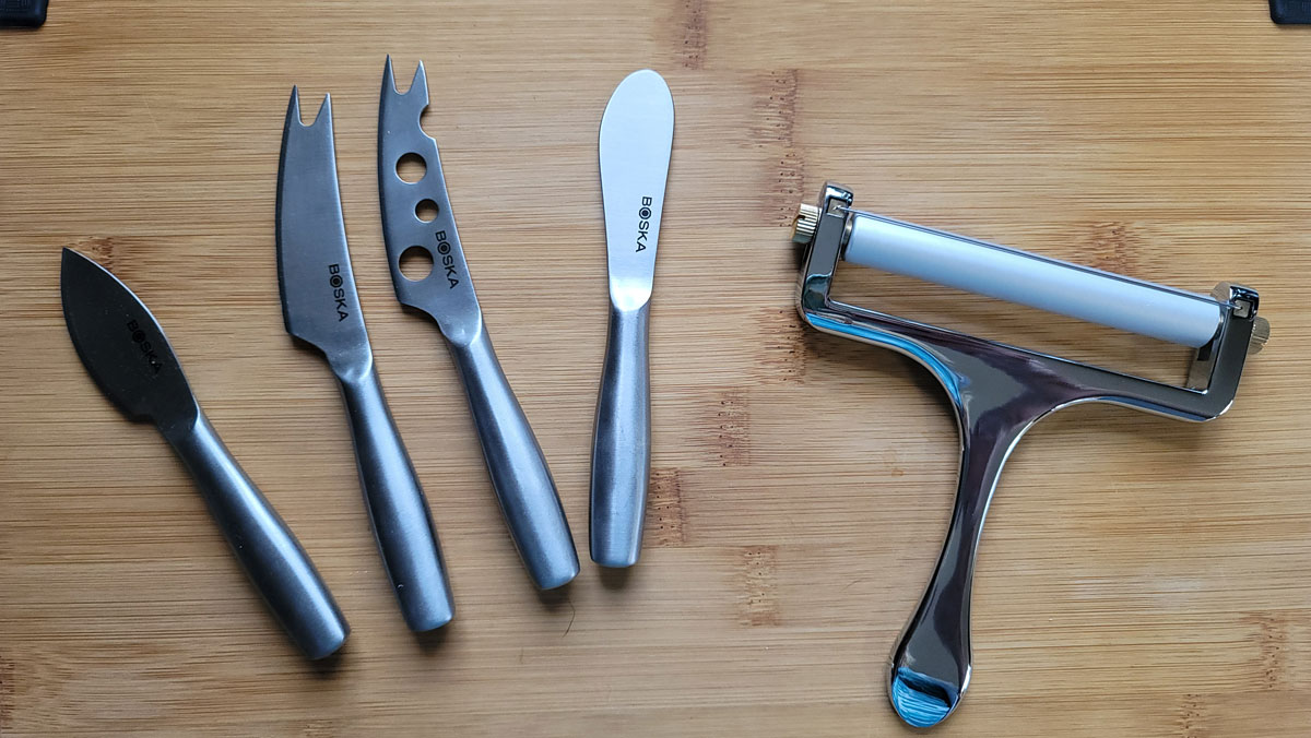 A collection of various cheese cutting tools.
