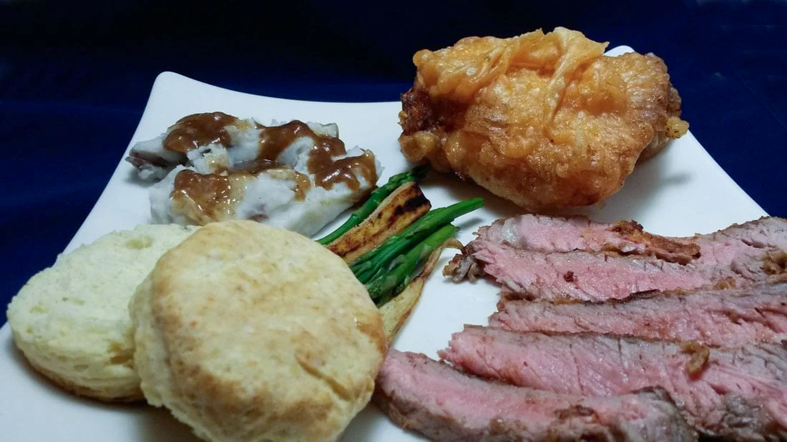 Slice chicken-fried steak on a white plate.