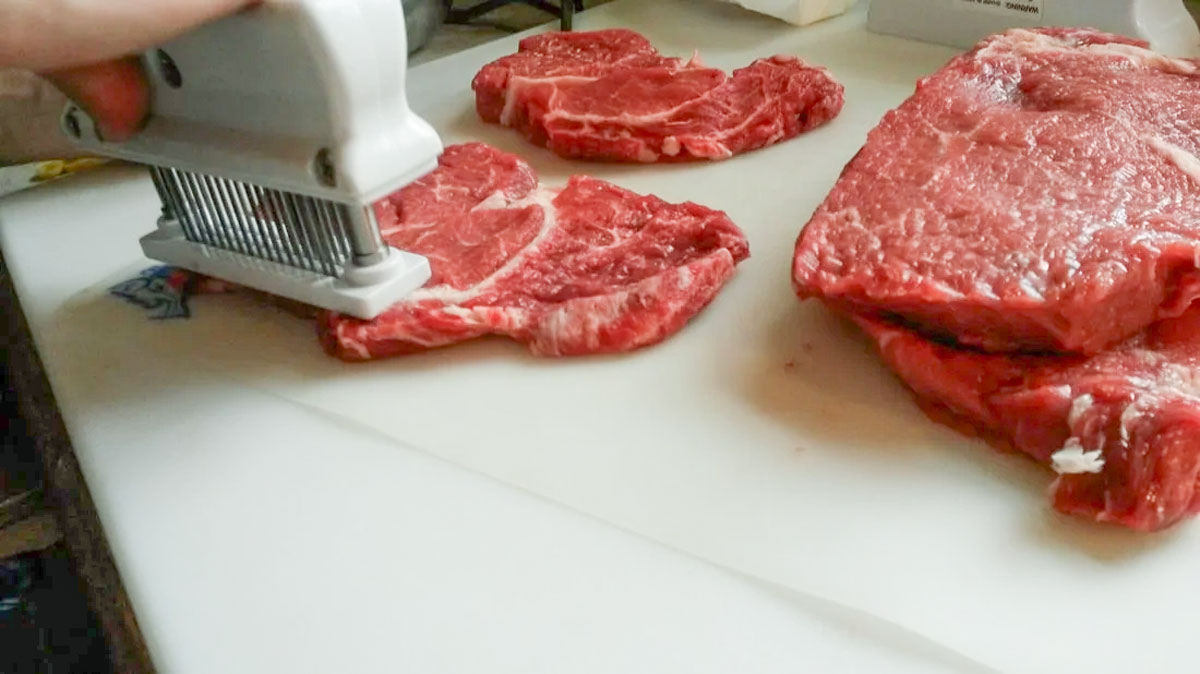 Tenderizing the steak.