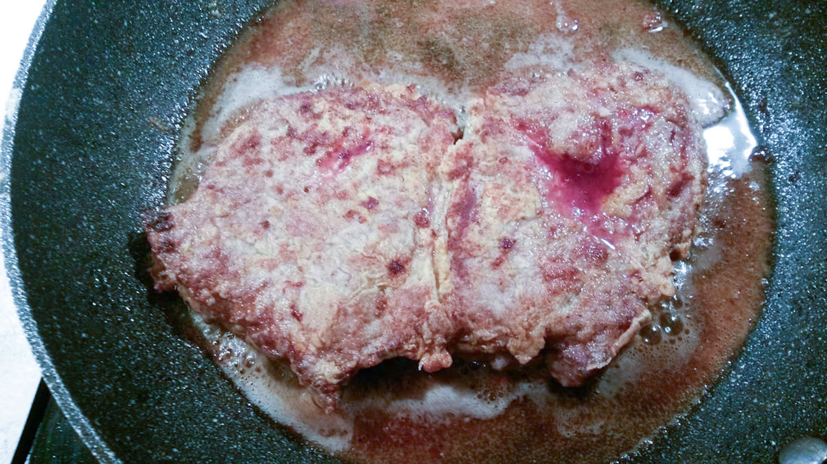 Meat in frying pan.