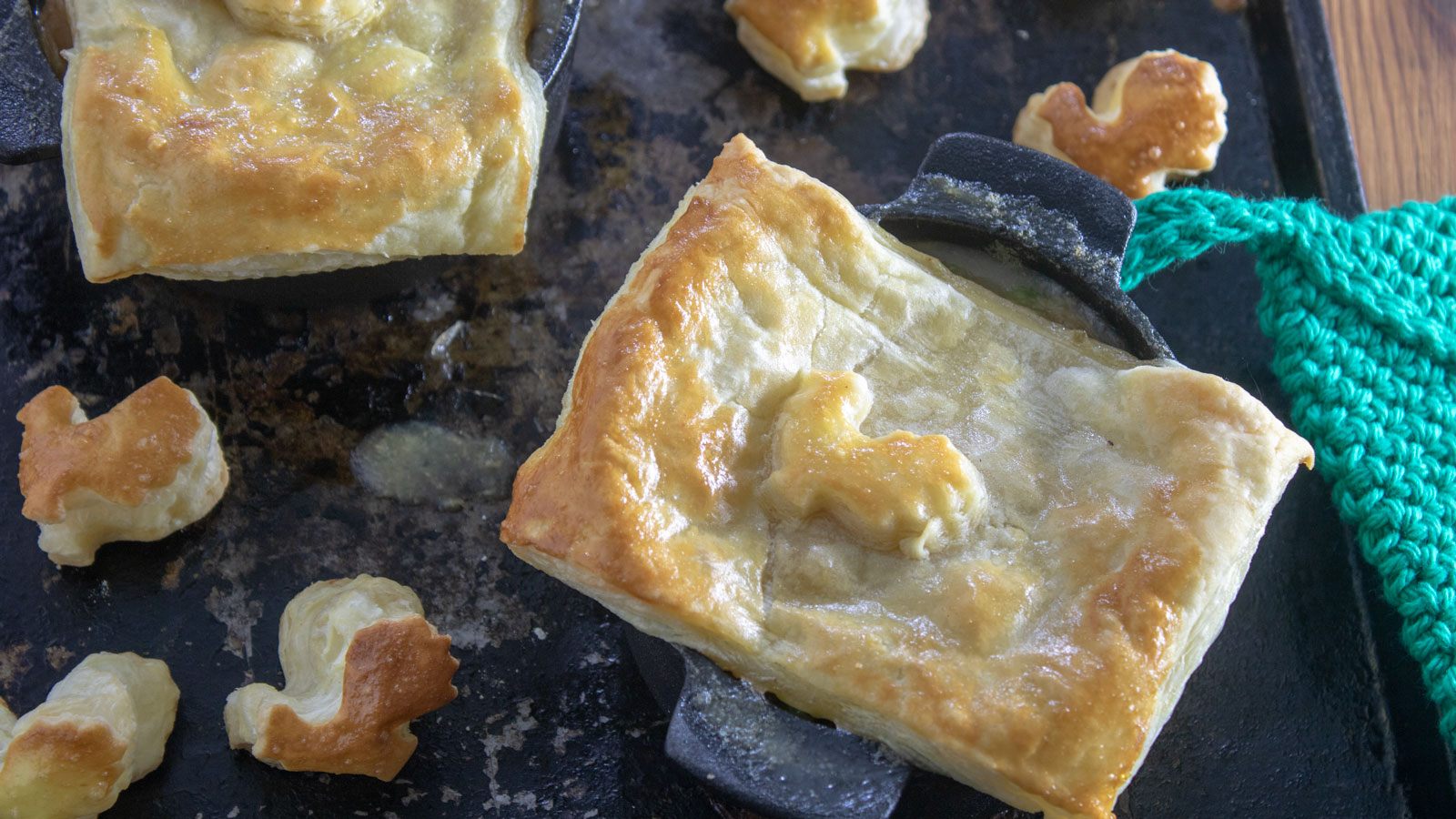 Chicken pot pie in individual cast iron Dutch ovens.