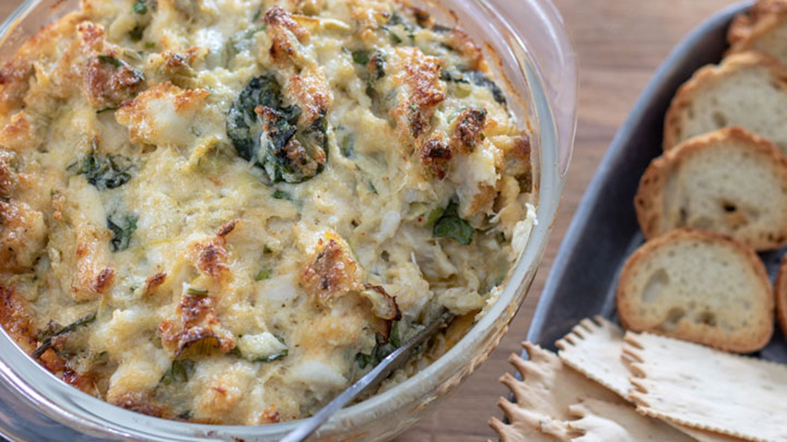 Crab and spinach dip in a small casserole.