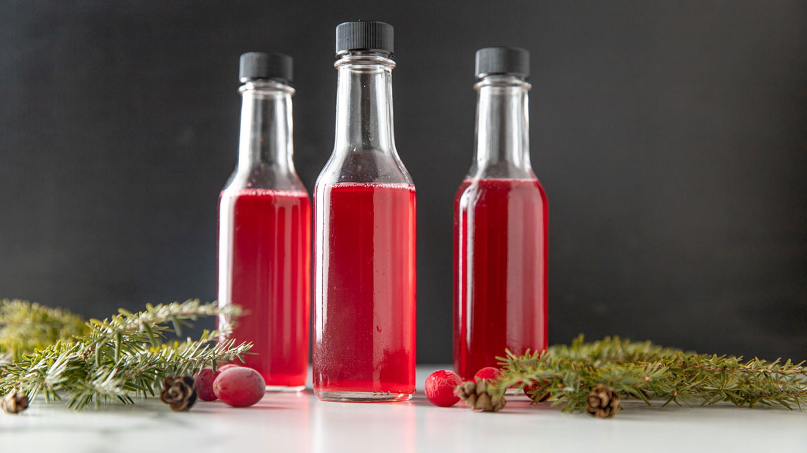 Cranberry vinegar in 3 small bottles.