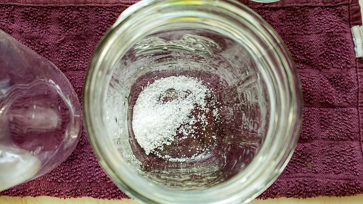 Salt added to a quart jar.