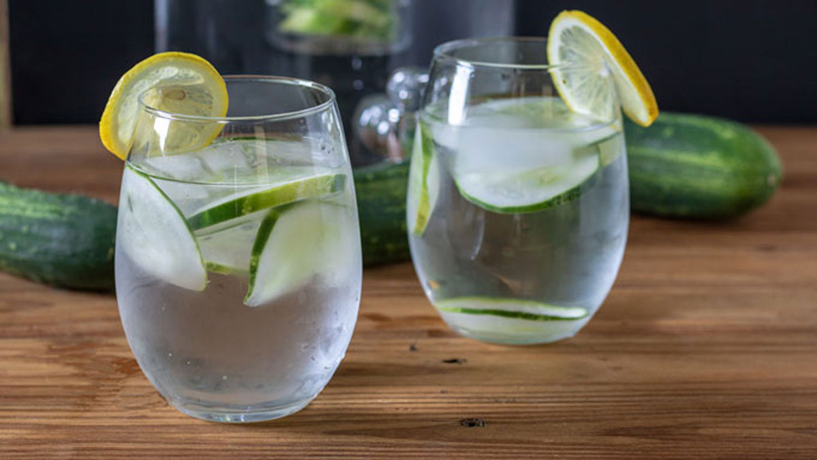 Antique green pitcher with detox water and two glasses.