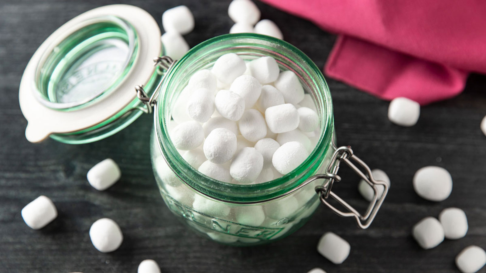 Dehydrated marshmallows in a green storage jar.
