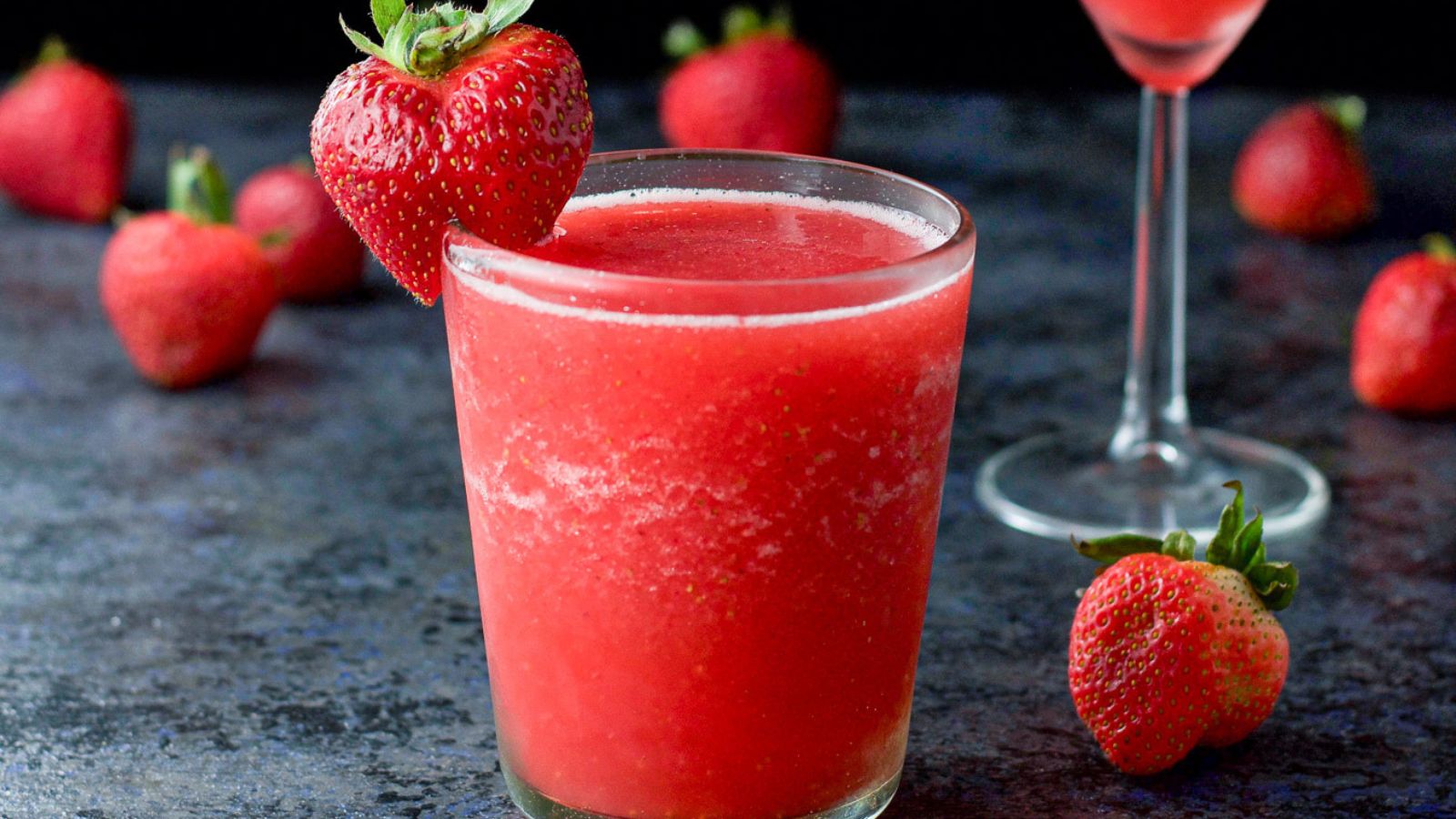 Frose cocktail with strawberry in a glass.