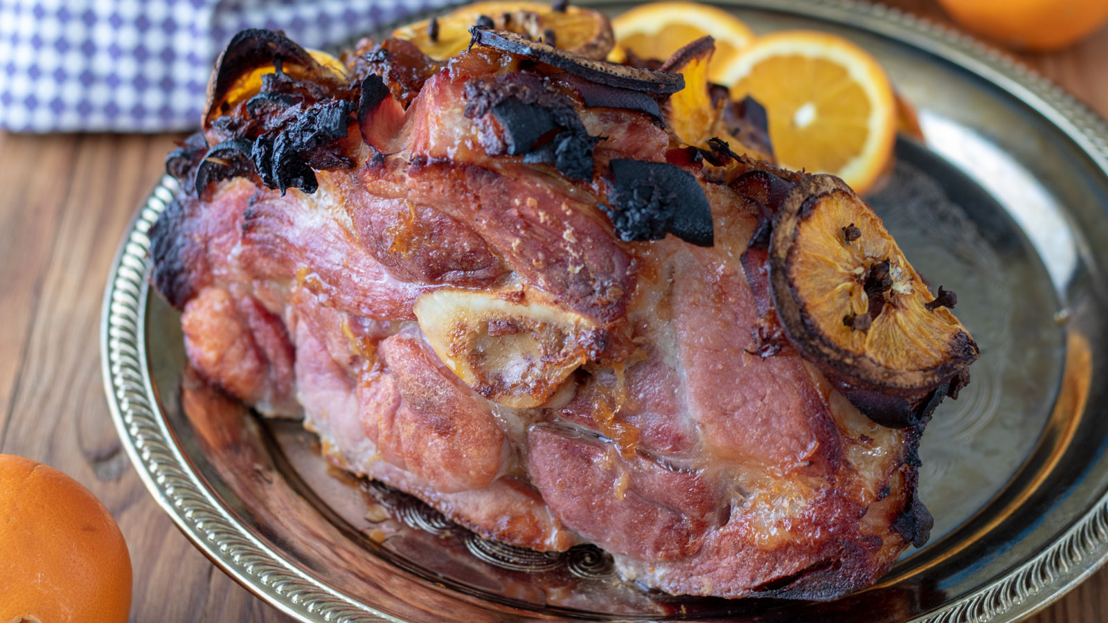 Ham with slices of oranges on the side.