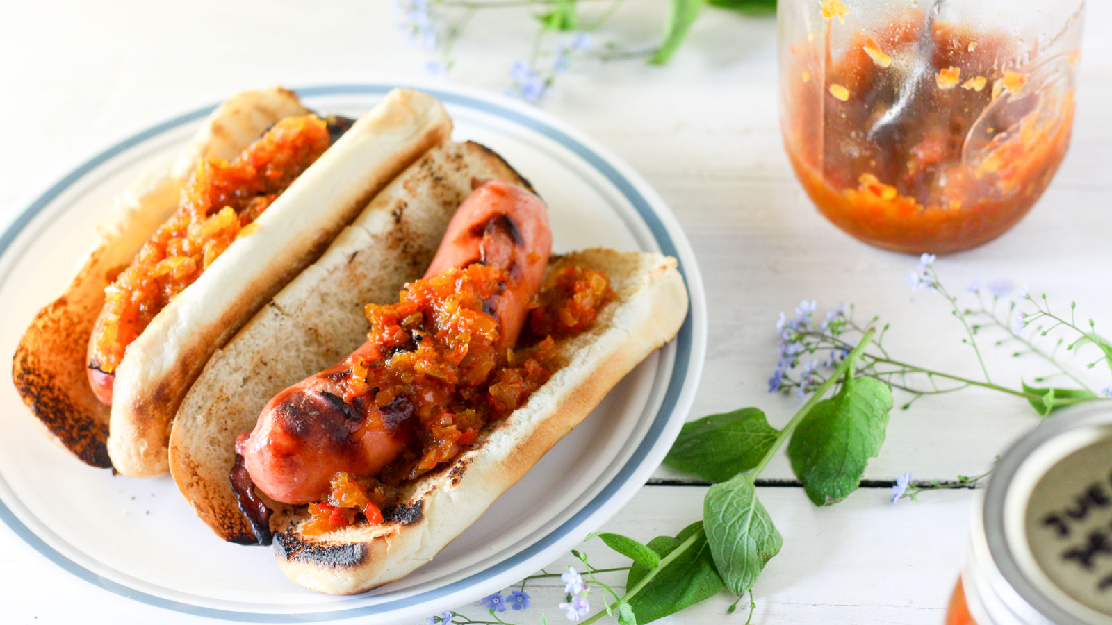 Pepper relish on a hot dog with a bun.