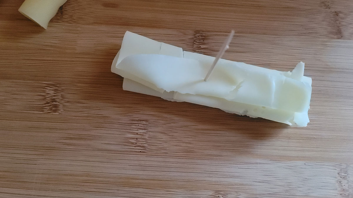 Folded cheese secured with a toothpick.