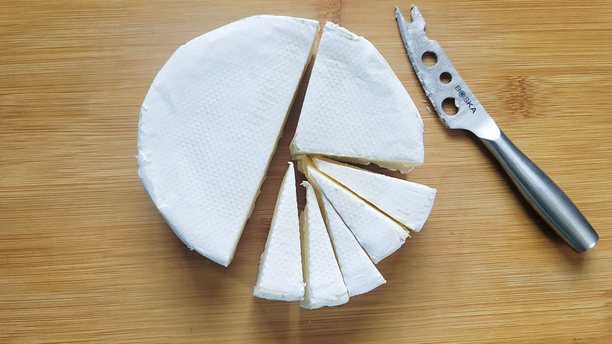 Wedges cut from the wheel of brie.