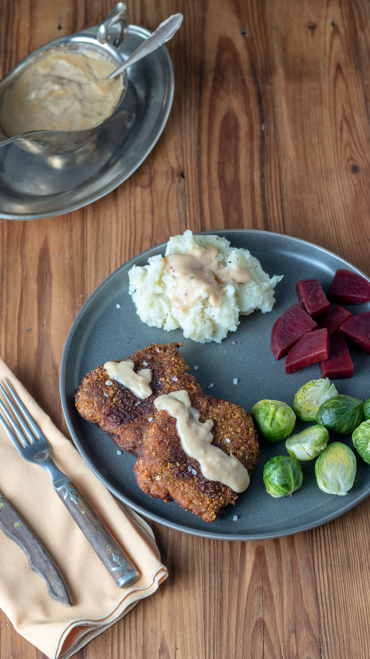Chicken fried venison covered with gravy.