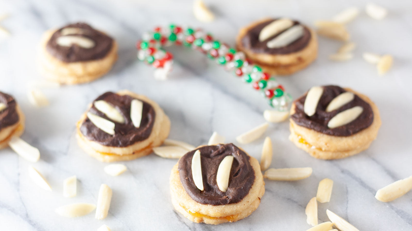 Chocolate topped cookies with almond slivers.