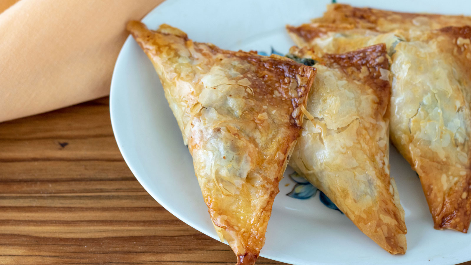 Lobsters wrapped in puffed pastry appetizers on a plate.