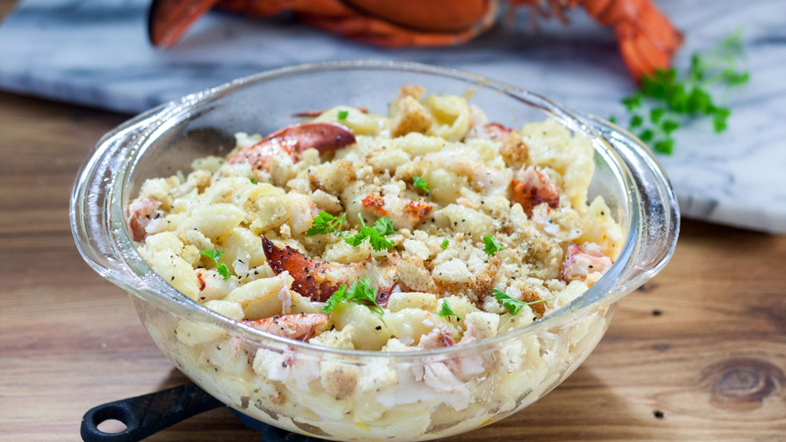 Lobster mac and cheese in a glass dish.