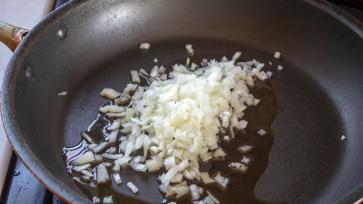 Onions in a skillet with oil.