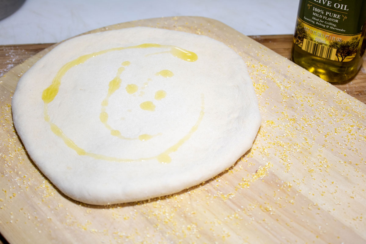Olive oil drizzled on the dough.
