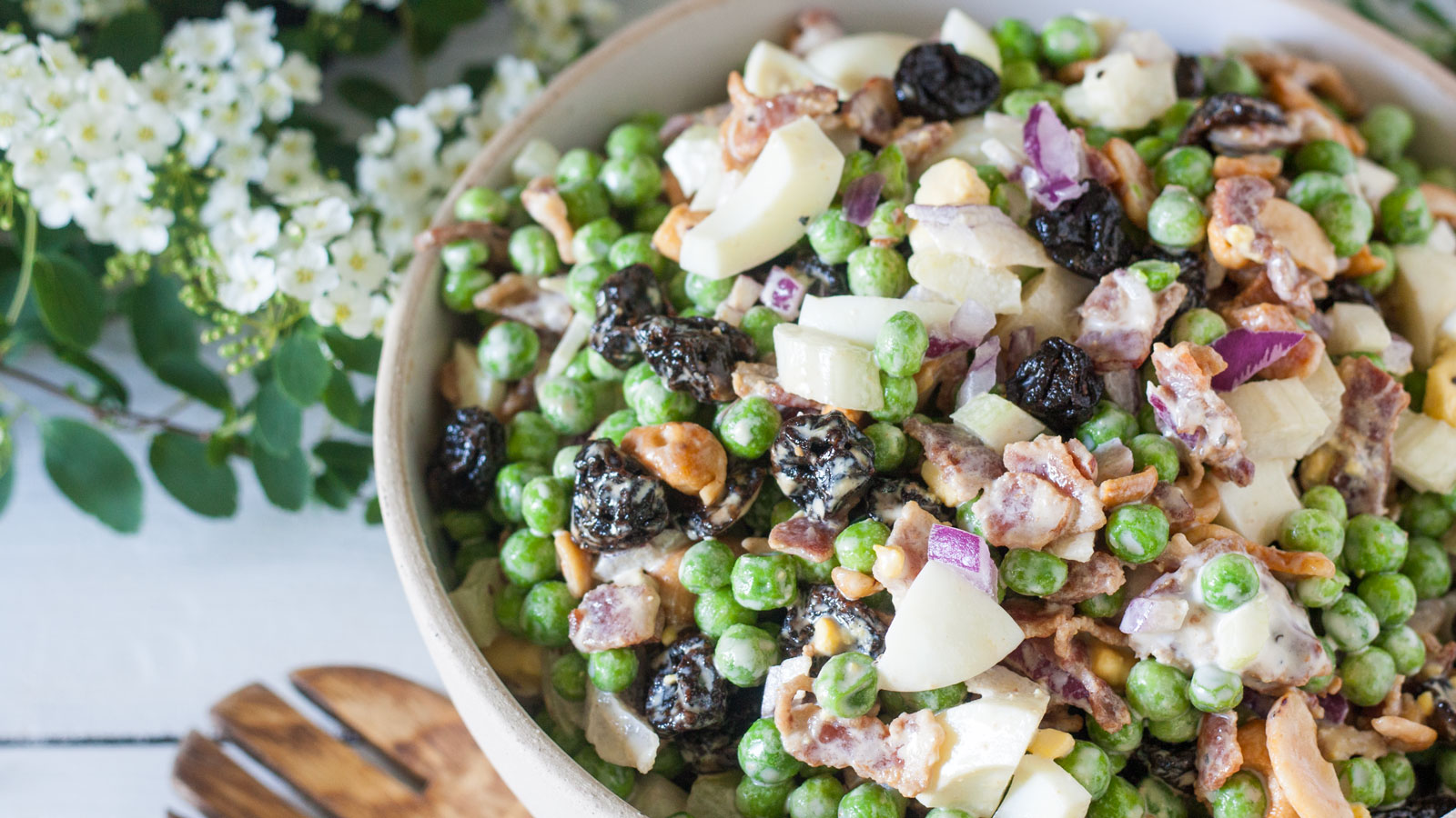 Large bowl filled with pea salad.