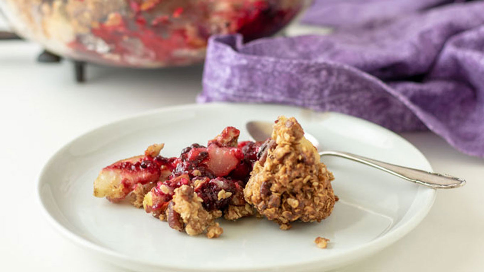 Blackberry crisp on white plate.