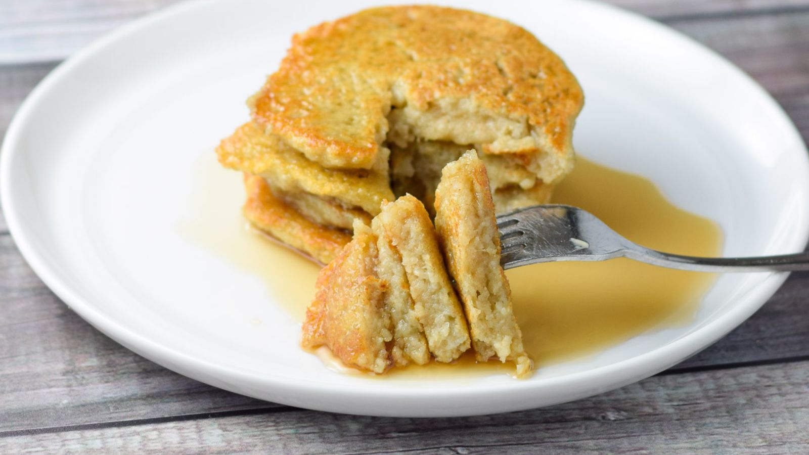 A stack of pancakes on a white plate.